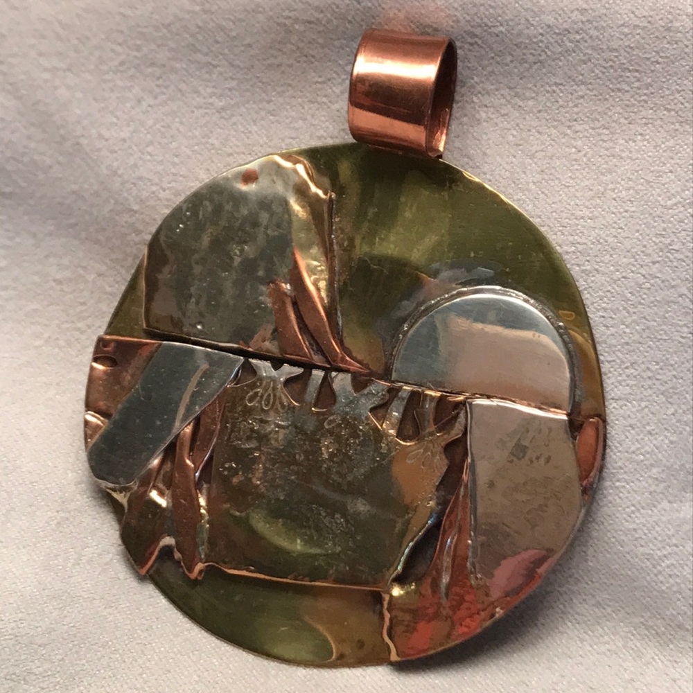 Copper and silver metal round pendant